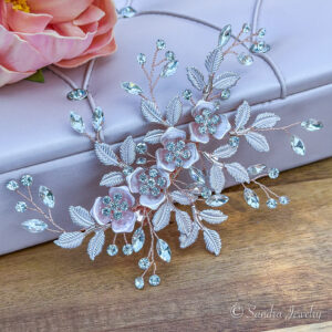 Radiant rose gold hair clip adorned with delicate blooms and shimmering rhinestones.