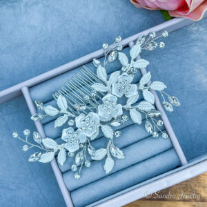 Bridal flower and leaf hair comb. Achieve the perfect wedding day look with a silver hair comb featuring a delicate blend of rhinestones, beads, and alloys.