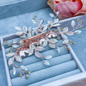 Radiant rose gold hair clip adorned with delicate blooms and shimmering rhinestones.